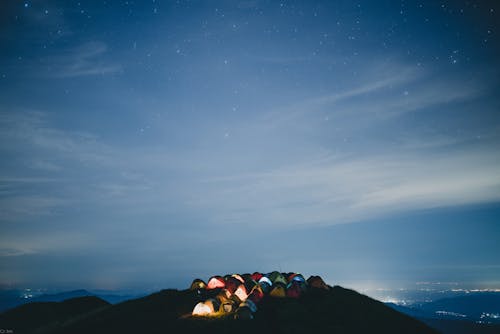 Tents on Top of the Hill Under Blue Sky