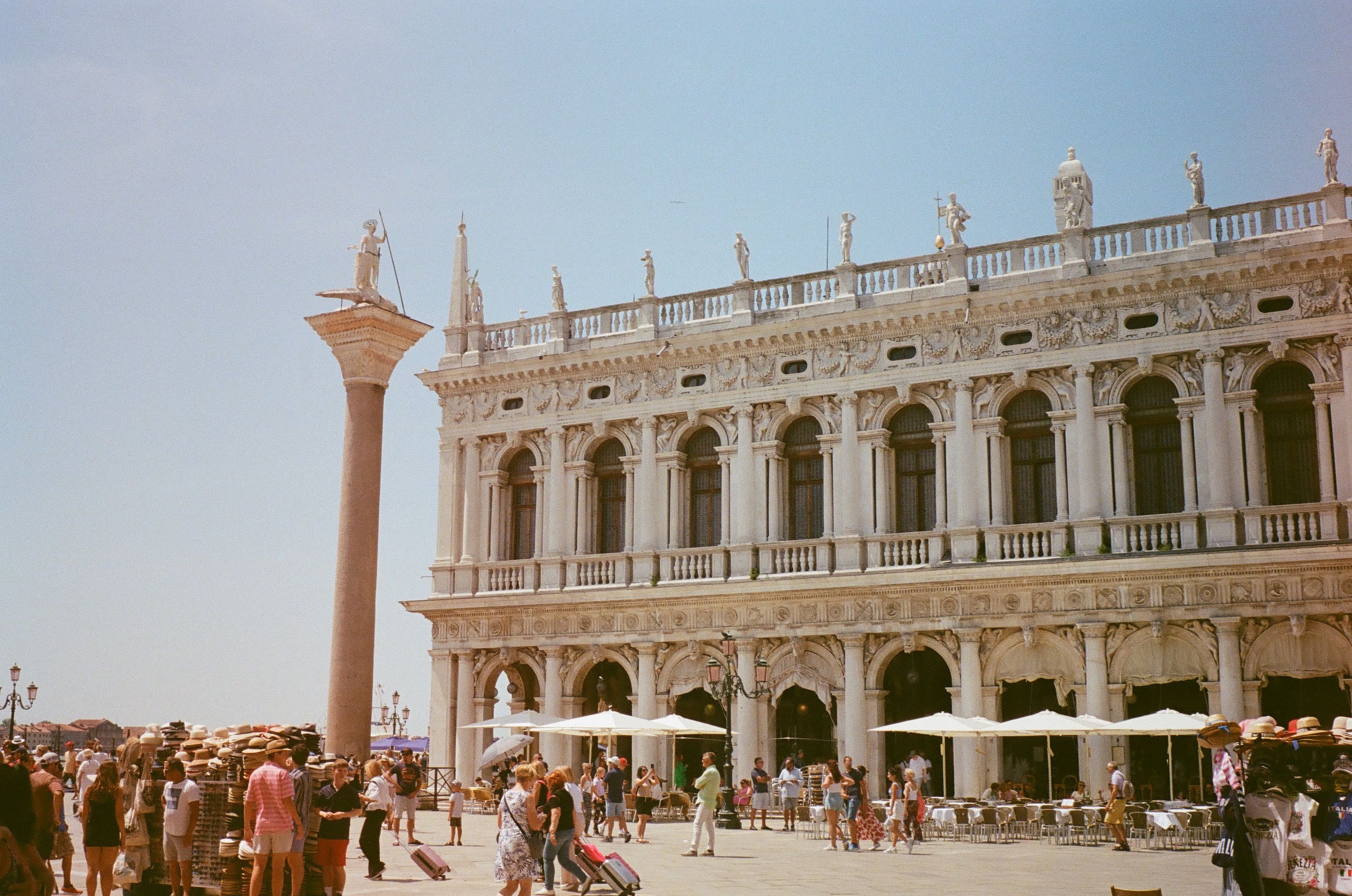 Crowds enjoying a sunny day at the Library of Saint Mark in Venice, Italy.