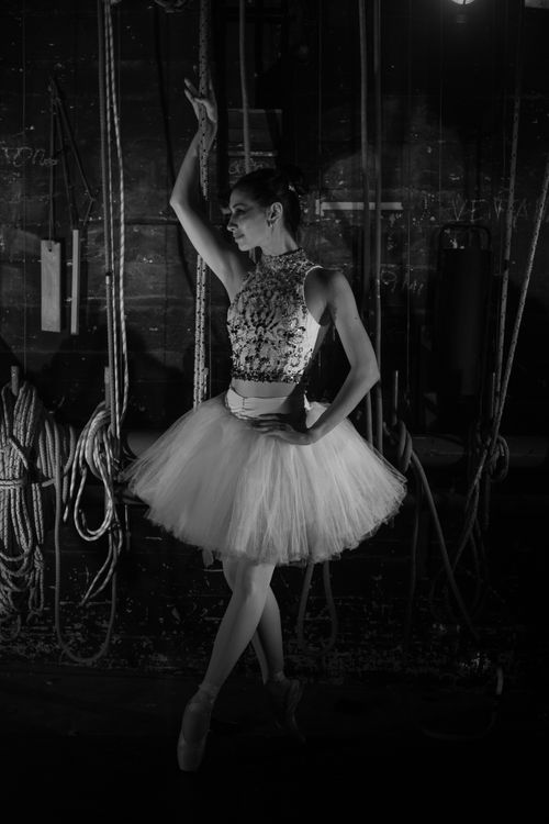 Free Elegant ballerina posing backstage, captured in monochrome for a dramatic effect. Stock Photo