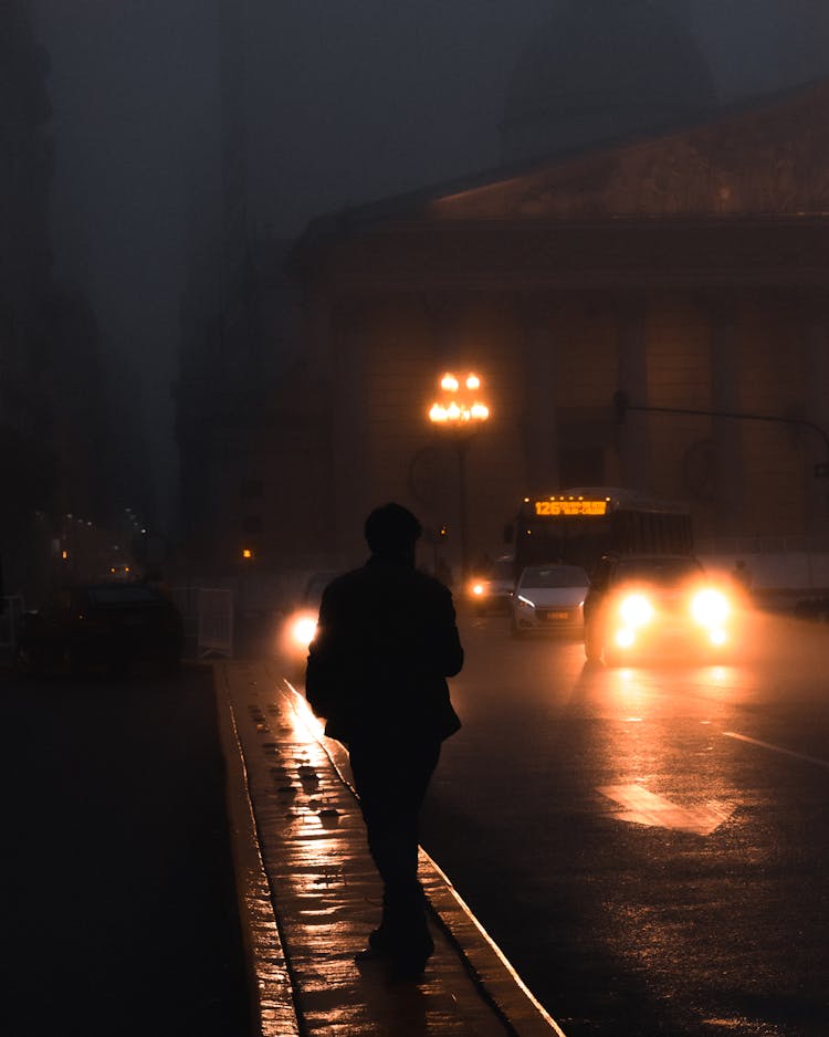 Walking On Sidewalk At Night