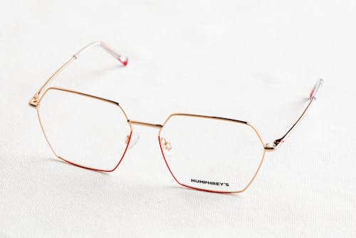 A Pair of Eyeglasses on a White Surface 