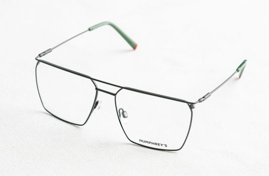 Stylish modern eyeglasses displayed on a white surface, showcasing minimalist design and elegance.