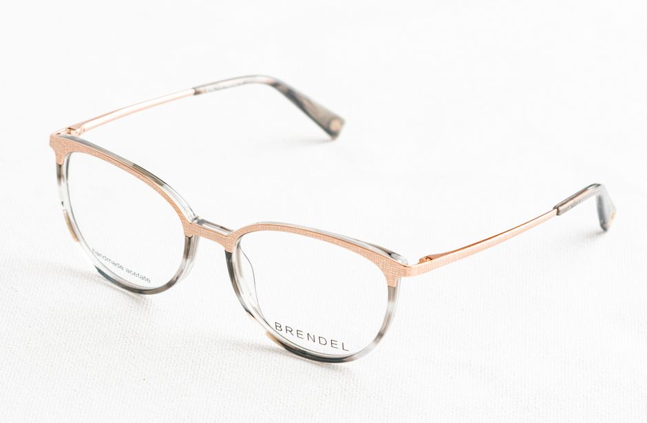 Stylish round eyeglasses with thin metal frame resting on a white surface, perfect for modern fashion and eyewear themes.