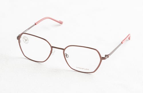 A Pair of Eyeglasses on a White Surface 