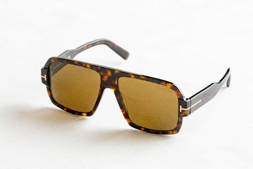 Free Sunglasses on a White Surface Stock Photo