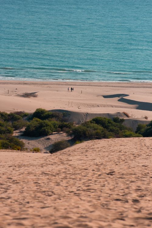 Free Explore the serene sand dunes and turquoise sea in Antalya, Turkey. Perfect for a summer getaway. Stock Photo