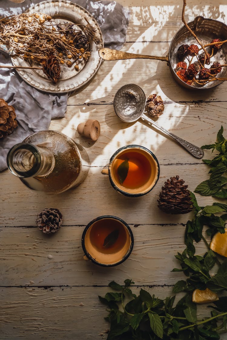 Herbs And Nuts In Pot, Jars And On Plate