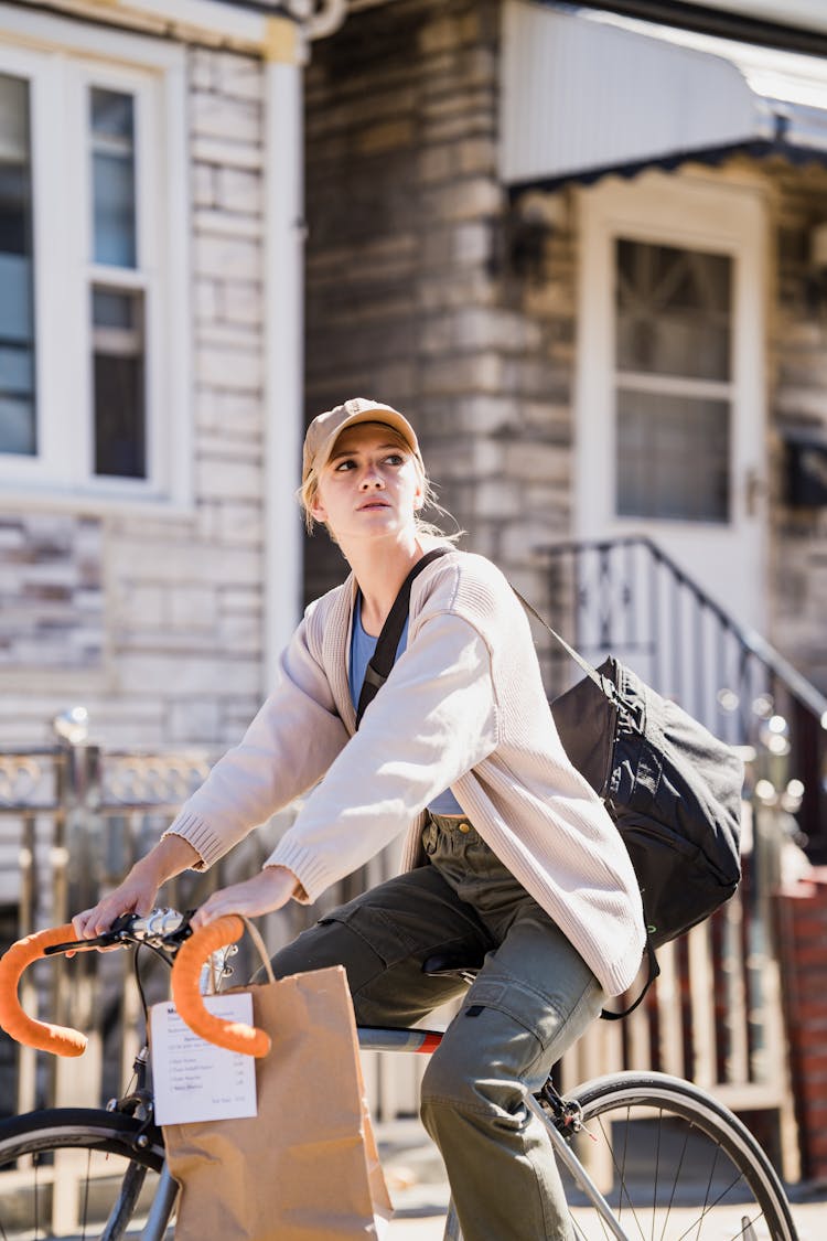 Delivery Woman On Bike Looking For Address