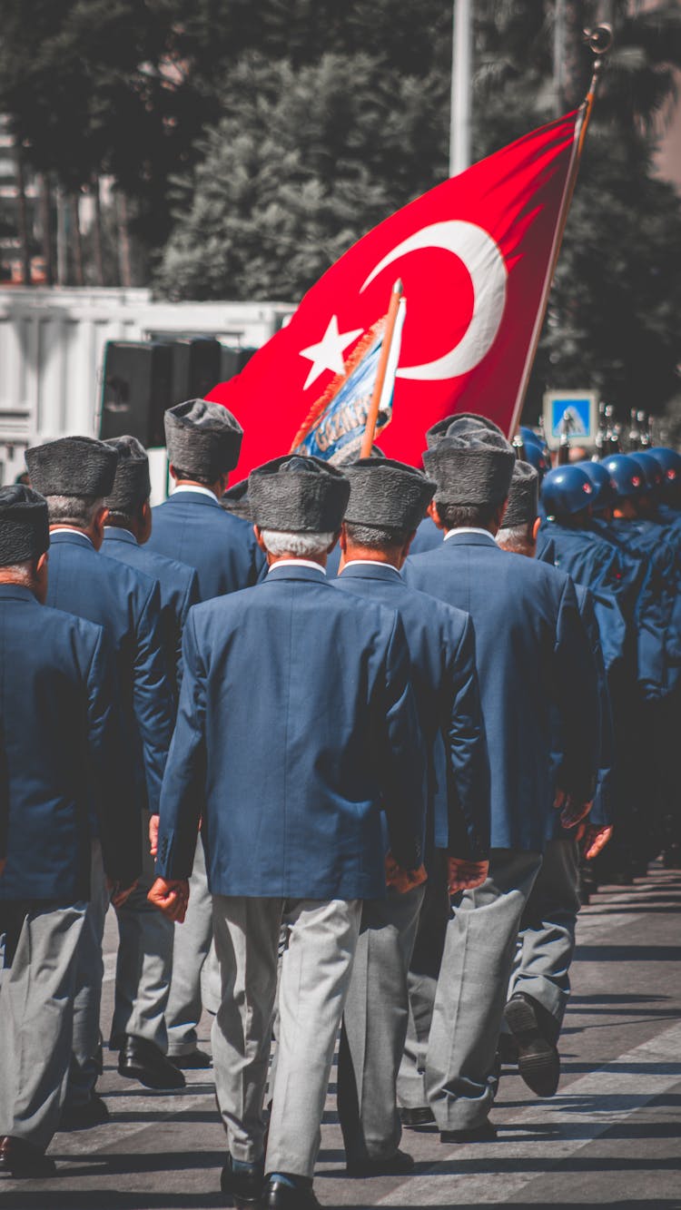 Backview Of Army Veterans On A Parade