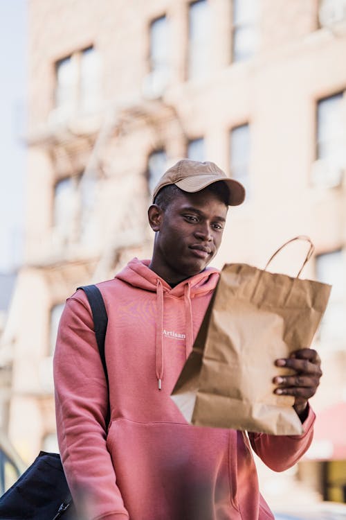 Delivery Man Holding a Paper Back with an Order