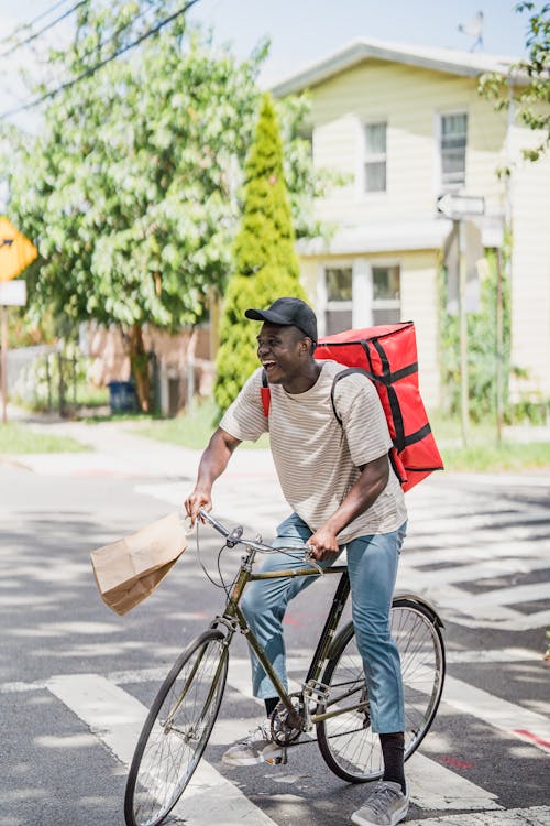 Smiling Courier Delivering Order on Bike