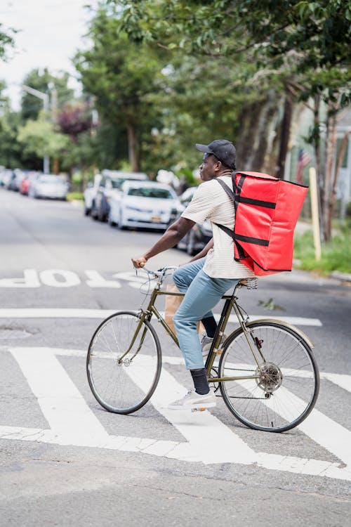 Deliveryman with Backpack on Bike Outdoors