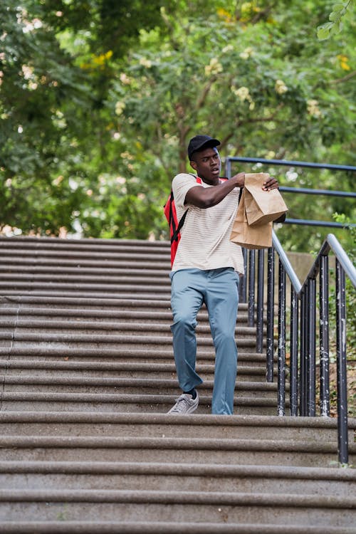 Deliveryman with Order Running Stairs Outdoors