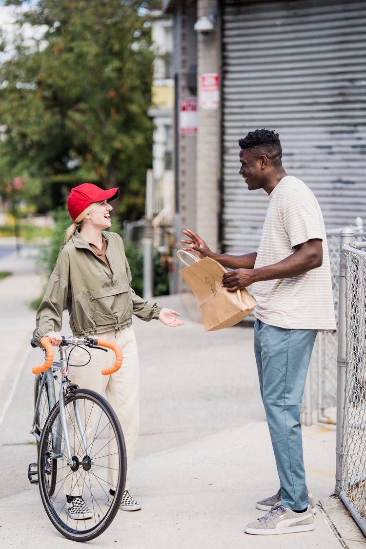 Smiling Courier On Bike Delivering Package 