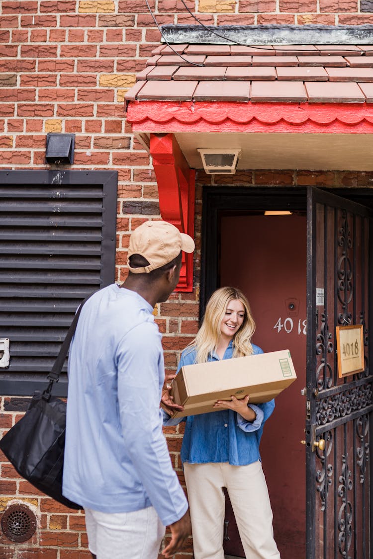 Woman Standing At Door With Package