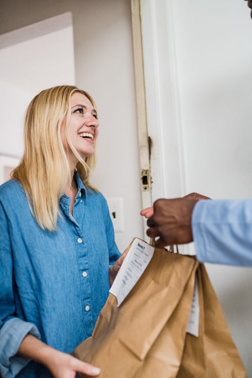 Smiling Woman Receiving Ordered Food · Free Stock Photo