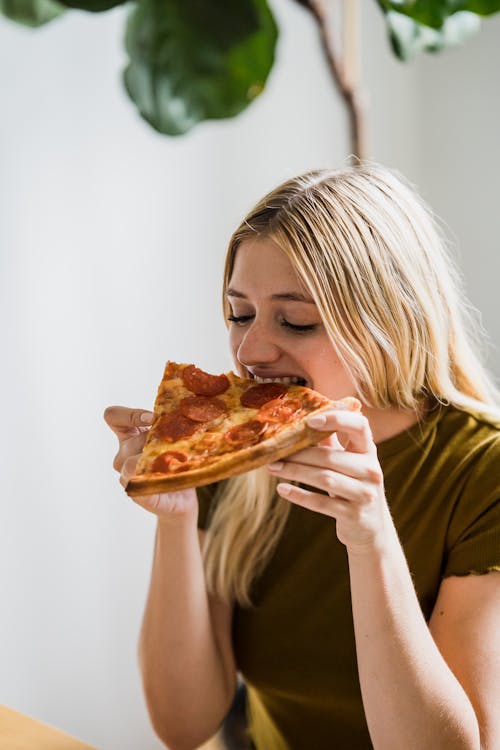 Woman Eating Pizza on Lunch