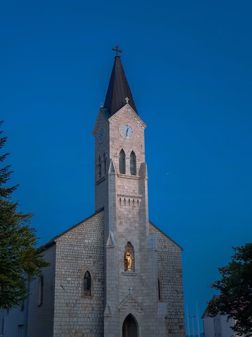 Gray Concrete Building of Church Under Blue Sky