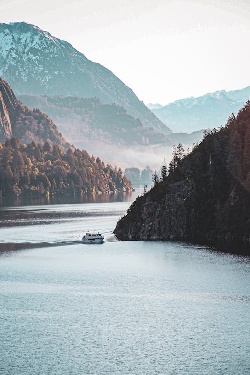 Ferry Sailing near Hills with Forest