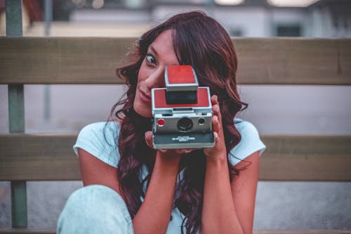 Woman Holding Red Camera