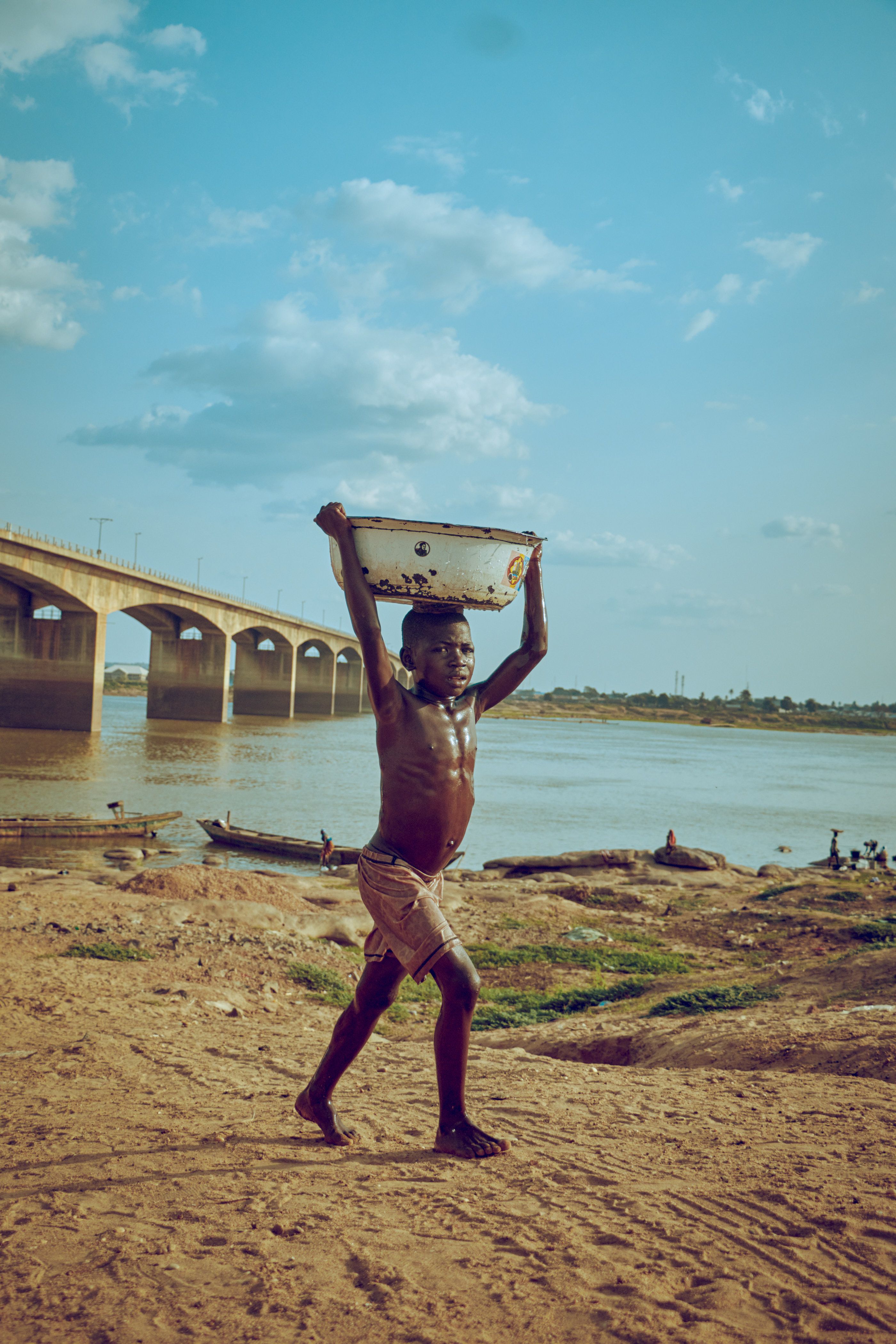 A Boy Carrying Basin on His Head · Free Stock Photo