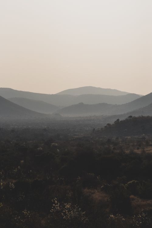 Free Serene landscape of South African hills and valleys at dusk with a misty atmosphere. Stock Photo
