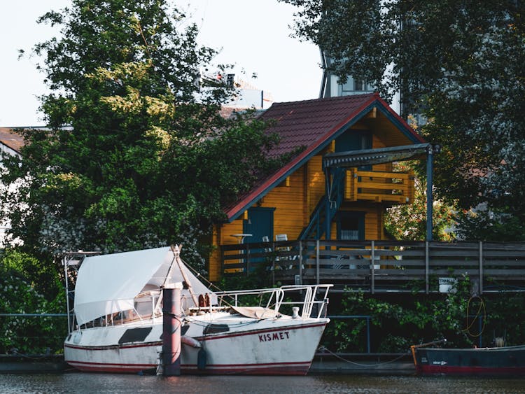 Boats Docked By A House With A Deck