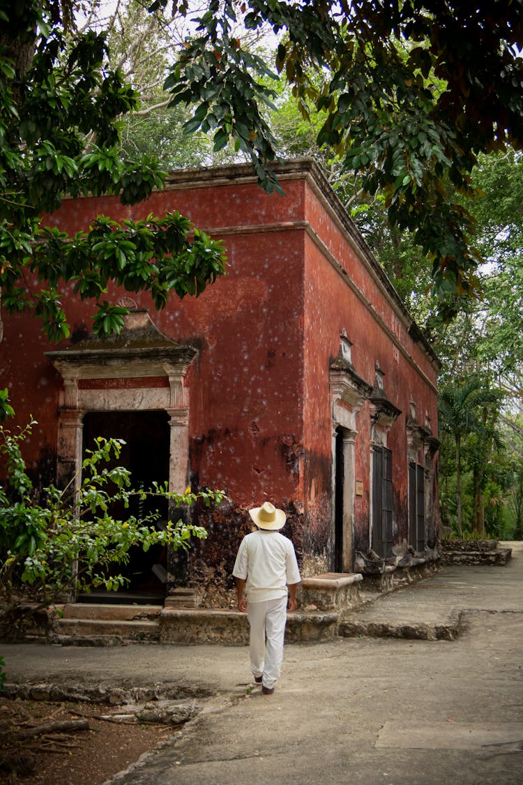 Person In Hat Walking Near Building