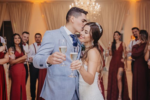 A Newlywed Couple Holding Champagne Glasses