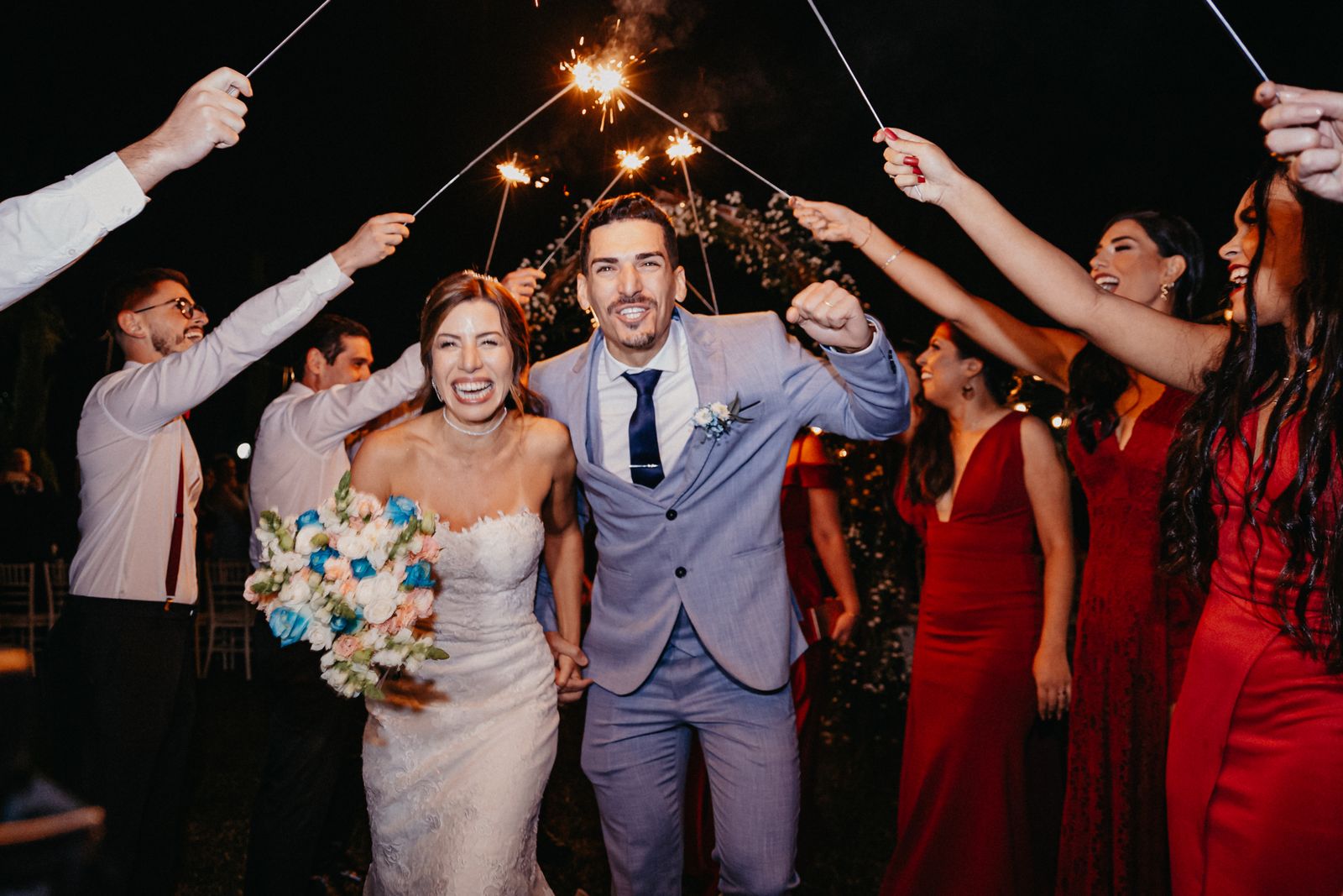 Newlyweds walking through a sparkler send-off - RPD Limo wedding transportation NJ