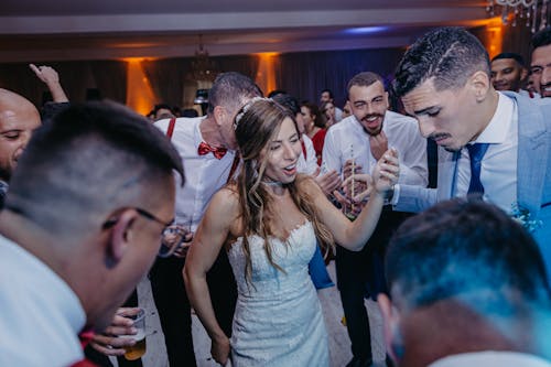 Bride, Groom and Wedding Guests Dancing at the Wedding Reception 