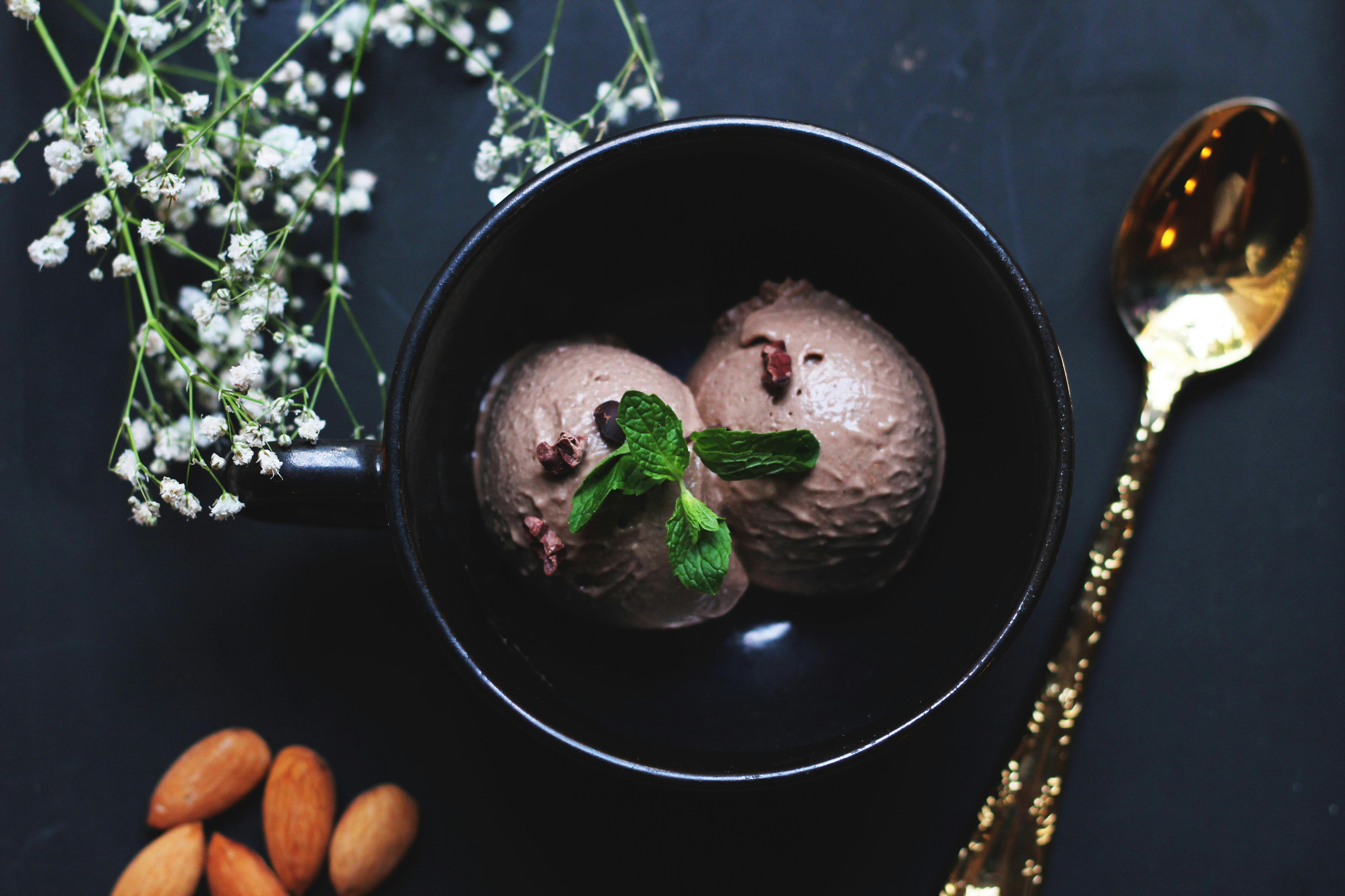 ice cream on bowl beside spoon