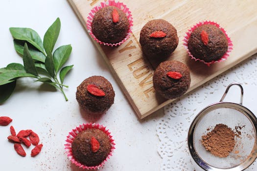 Tasty chocolate cupcakes topped with goji berries, perfect for a sweet treat.