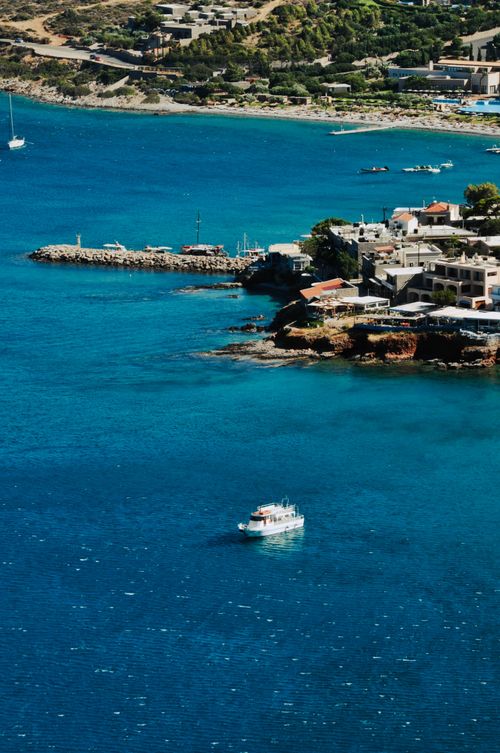 Free A stunning aerial view of Plaka, Greece, showcasing the vibrant coastline and crystal-clear sea. Stock Photo