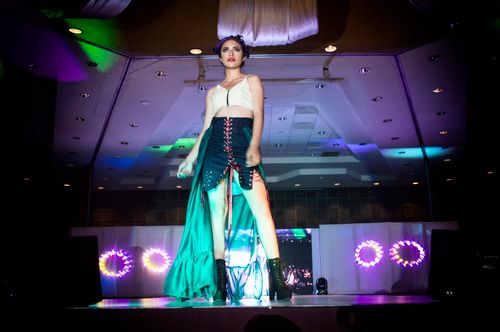 Free Fashion model strutting on a runway during a glamorous evening event with vibrant lights in Morelia, Mexico. Stock Photo