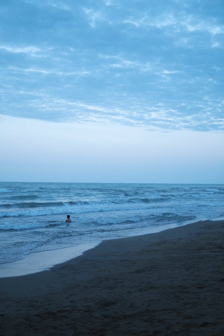 A Person Swimming At The Beach