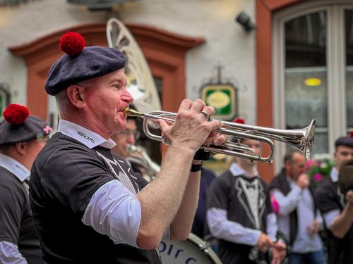 Free A street musician playing the trumpet in an outdoor festive parade with onlookers. Stock Photo