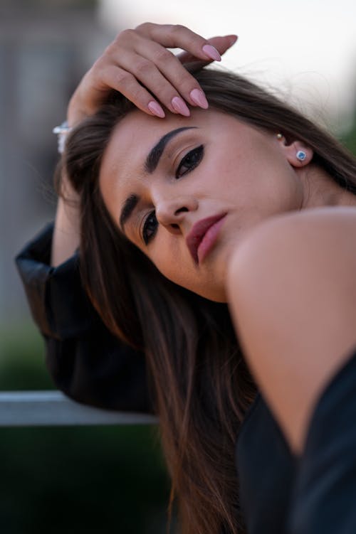 Close-up of a Beautiful Woman with Hand on Face