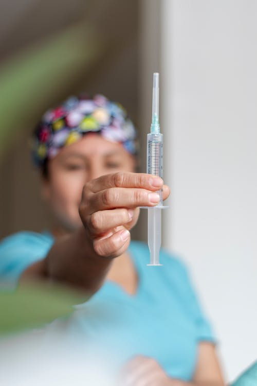 A Woman Holding a Syringe