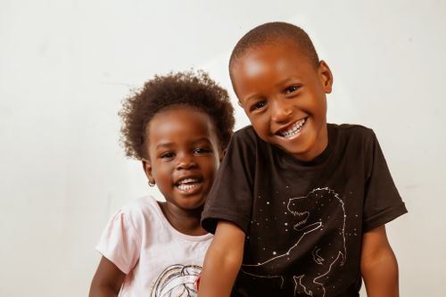 Free Joyful siblings smiling brightly, showcasing happiness and connection in Kampala, Uganda. Stock Photo
