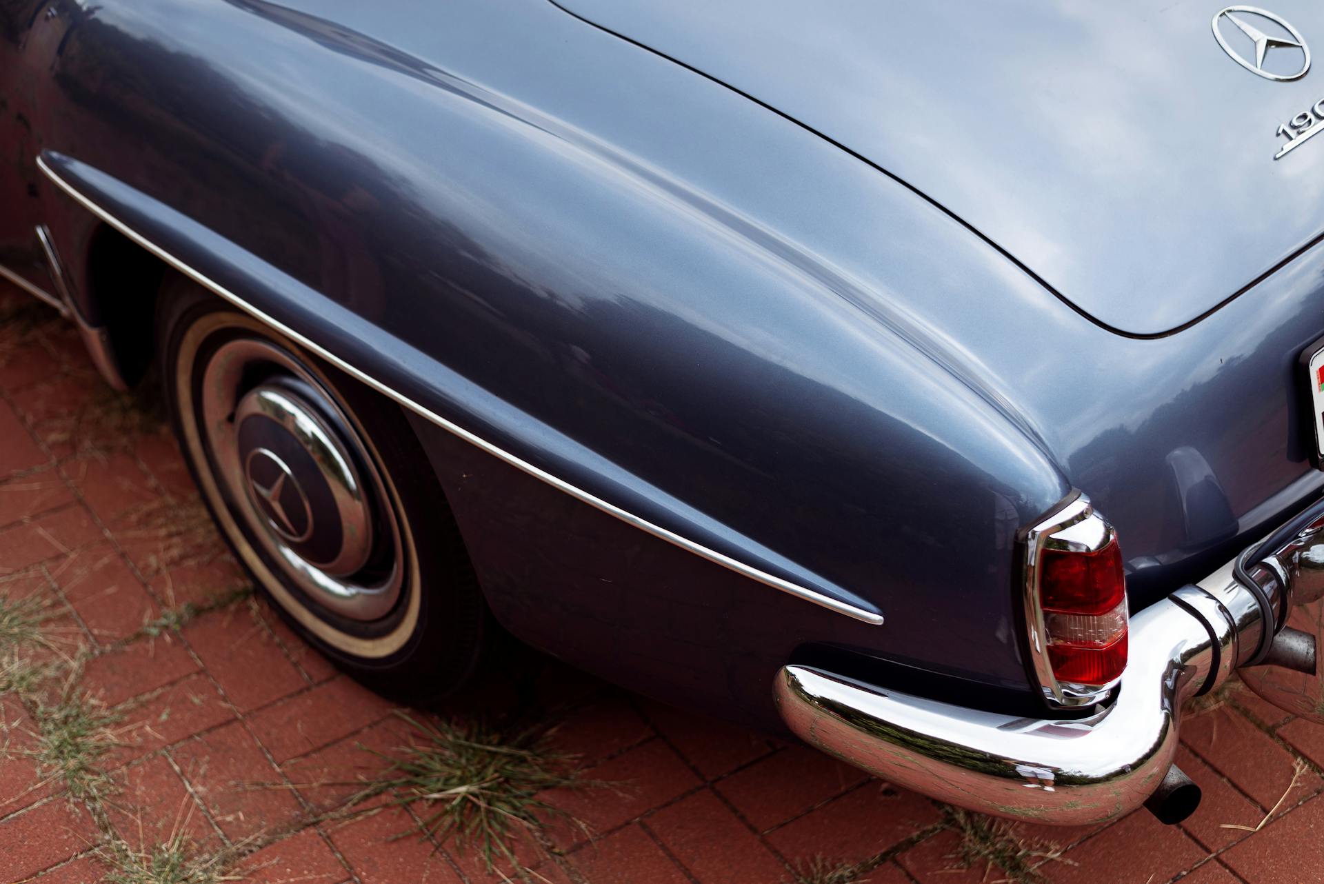 Close-up of a vintage Mercedes Benz convertible showcasing the shiny rear and chrome details.