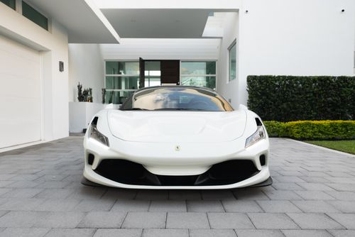 Free Luxury white sports car parked in a sleek modern driveway, showcasing elegance and design. Stock Photo