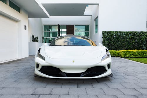 White Ferrari Parked in Front of White Building