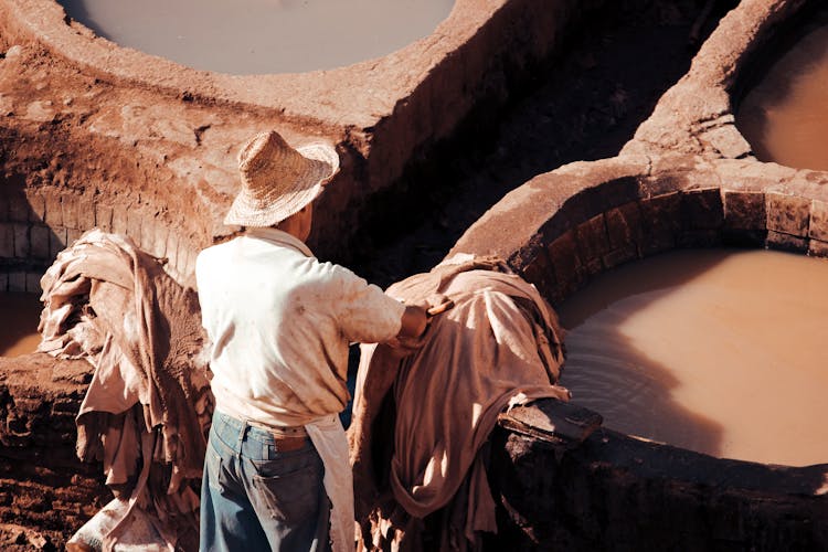 Man Tanning And Dyeing Leather