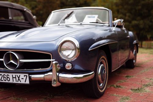 Free Classic Mercedes convertible showcased outdoors, featuring sleek design and chrome details. Stock Photo