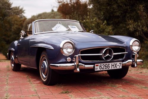 Free A vintage Mercedes-Benz convertible car parked outdoors on a brick path. Stock Photo