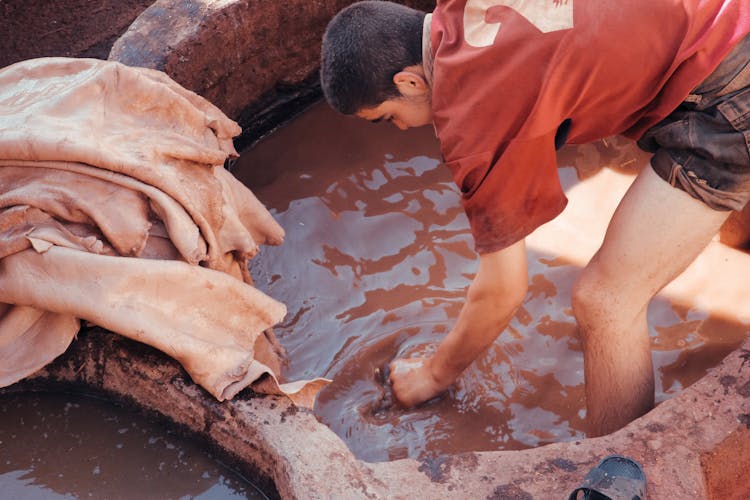 Man Tanning And Dyeing Leather