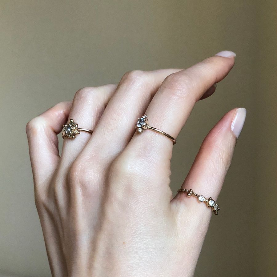 A hand wearing fine gold rings