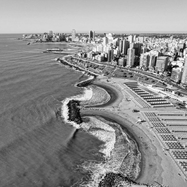 Black and white aerial view of Mar del Plata's coastline with cityscape in Buenos Aires, Argentina.