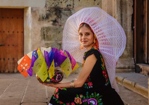 Free Portrait of a young woman in traditional Mexican attire enjoying a festive celebration in Oaxaca. Stock Photo